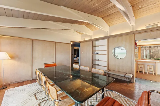 a kitchen with stainless steel appliances granite countertop a refrigerator a stove top oven a sink with island chairs and wooden floor