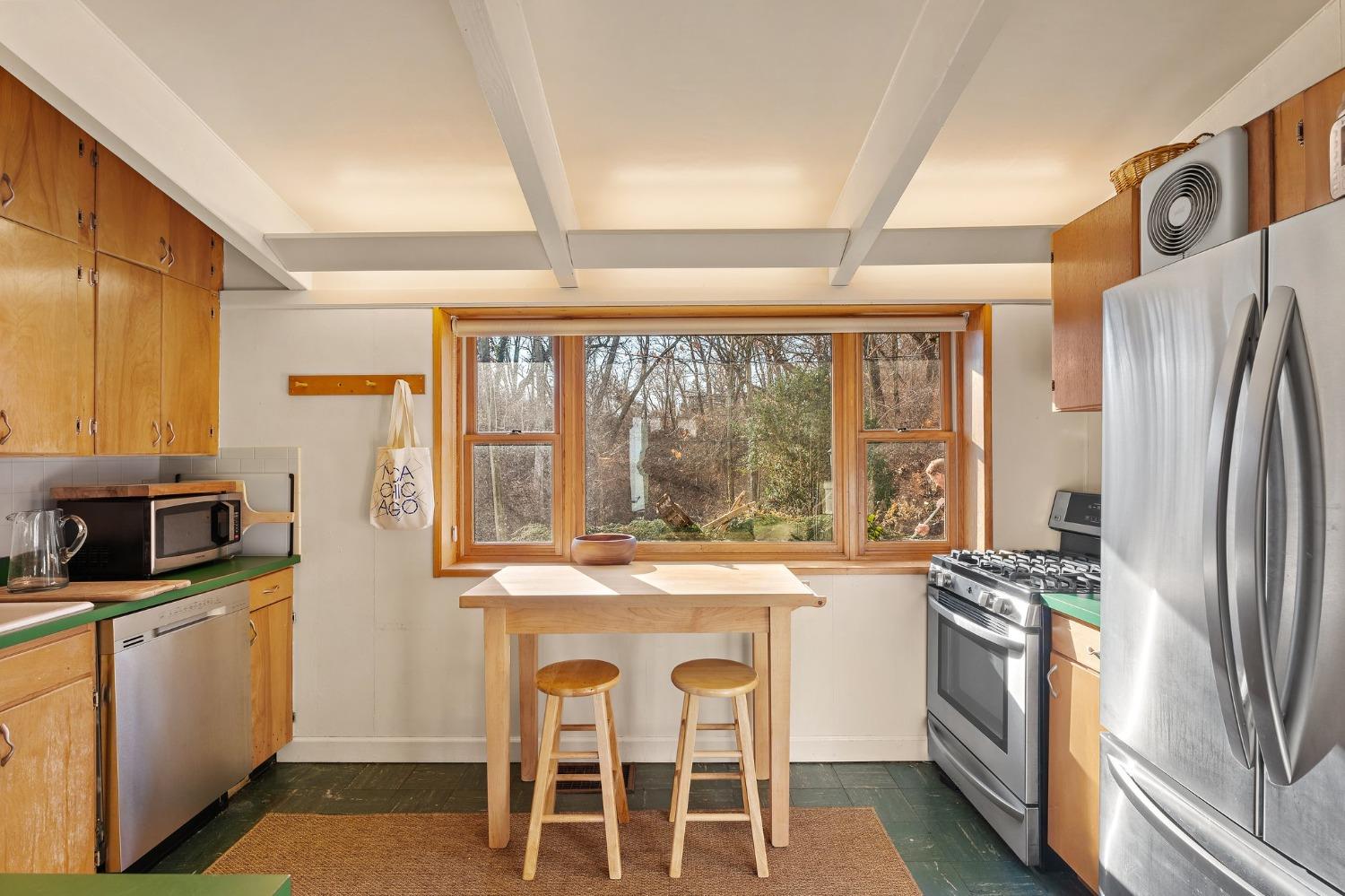 42 Circle Drive Dune Acres, IN 46304 - Photo 26 of 44 a kitchen with stainless steel appliances granite countertop a refrigerator a stove top oven a sink with island chairs and wooden floor