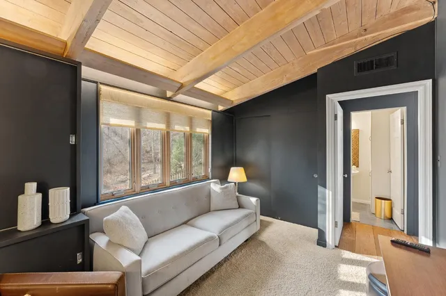 a bedroom with double bed and a large window