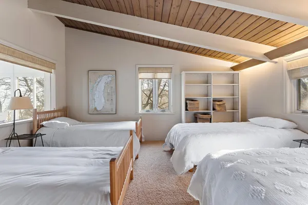 a bedroom with two beds and a large window