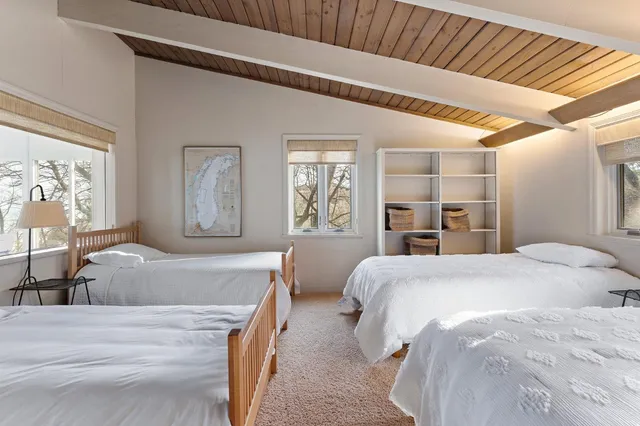 a bedroom with two beds and a large window