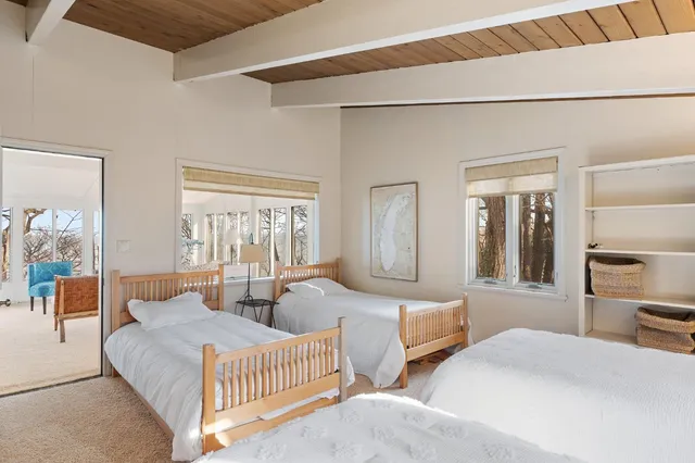 a living room with furniture a flat screen tv and a large window