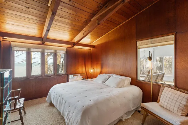 a room with pool table and windows