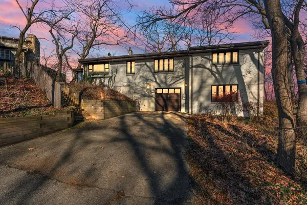 a view of a house with a large window and wooden fence