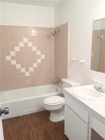 a white toilet sitting next to a white sink