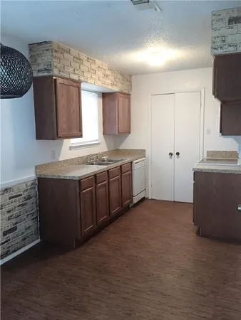 a utility room with granite countertop cabinets washer and dryer