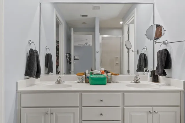a bathroom with double vanity sink and a mirror