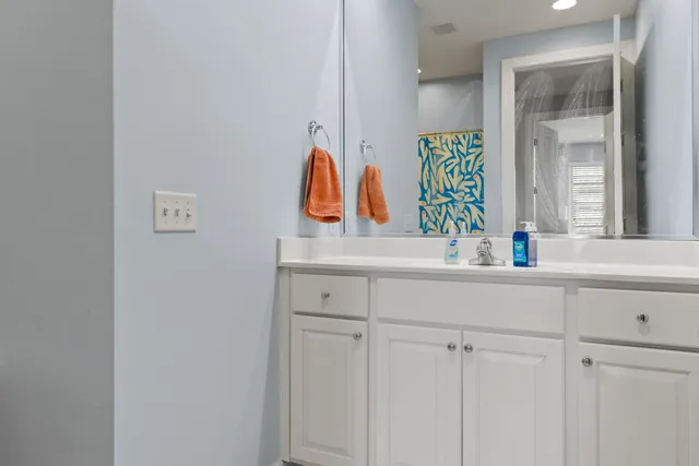 a bathroom with a toilet and a shower curtain