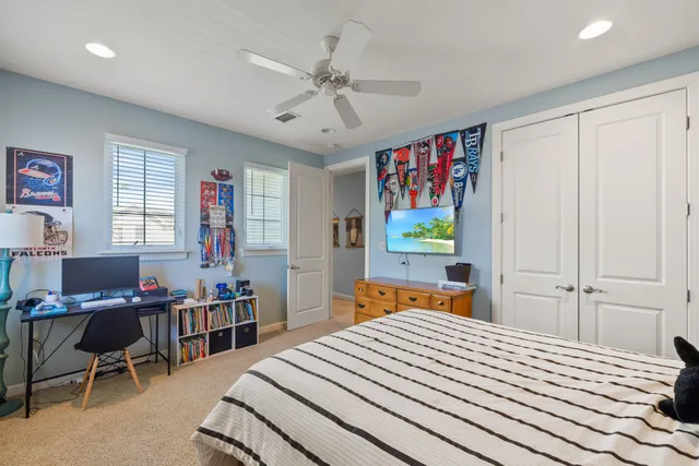 a bedroom with a bed wooden floor and window