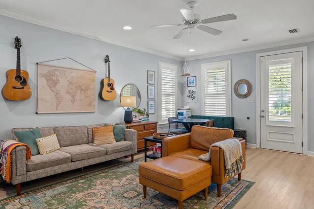 a living room with furniture and wooden floor