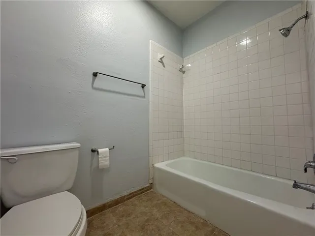 a bathroom with a shower and a toilet