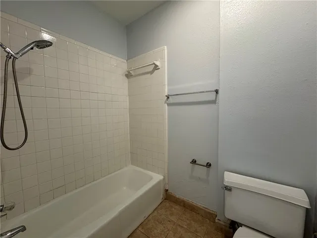 a view of an empty room with a ceiling fan