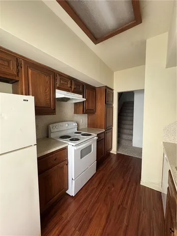 a kitchen with a stove a sink and a refrigerator