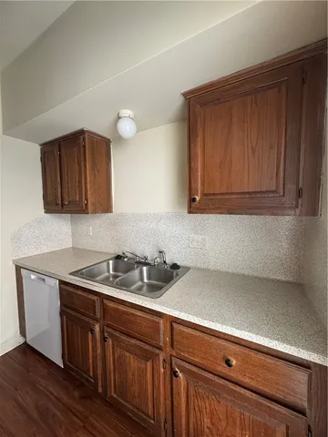a kitchen with stainless steel appliances granite countertop a sink a stove and cabinets