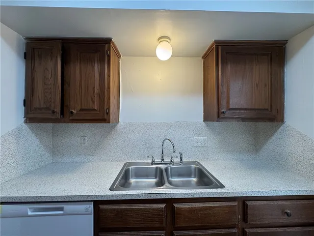 a kitchen with a sink and cabinets