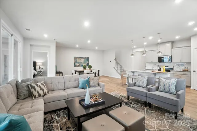 a living room with furniture and kitchen view