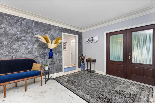 a room with kitchen island granite countertop a stove a sink and a refrigerator