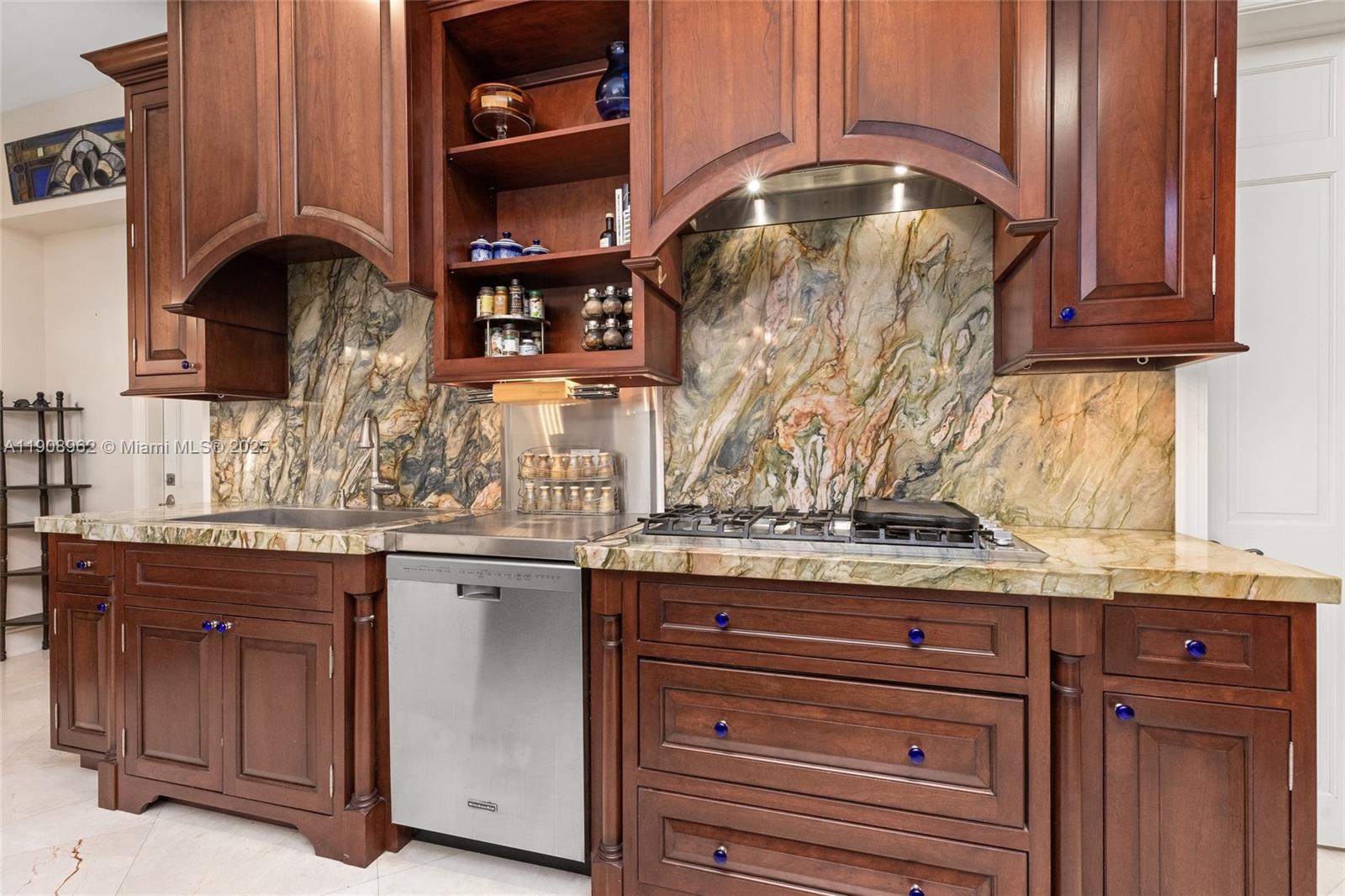 70 Bay Colony Lane Fort Lauderdale, FL 33308 - Photo 26 of 97 a kitchen with stainless steel appliances granite countertop a sink and cabinets