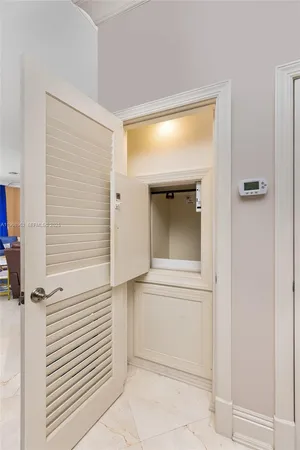 a bedroom with a bed and large windows