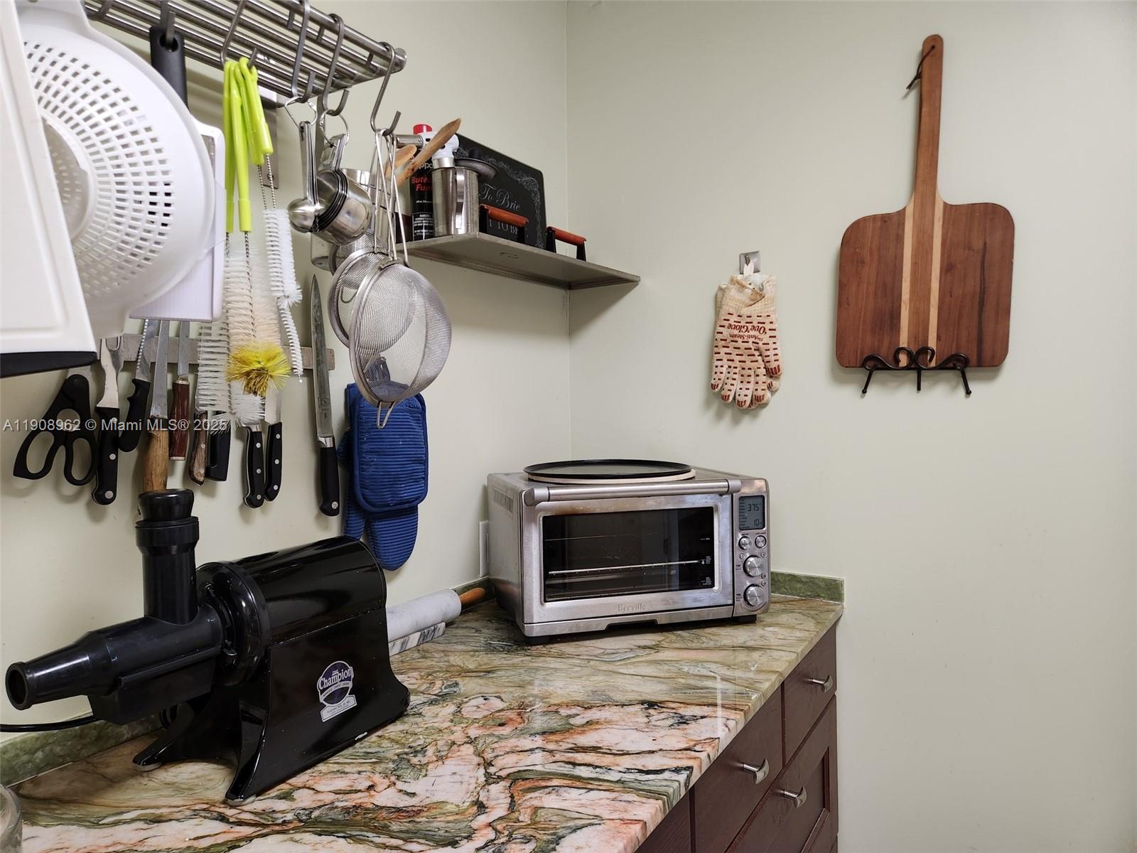 70 Bay Colony Lane Fort Lauderdale, FL 33308 - Photo 38 of 97 a kitchen with a stove and a wooden floor