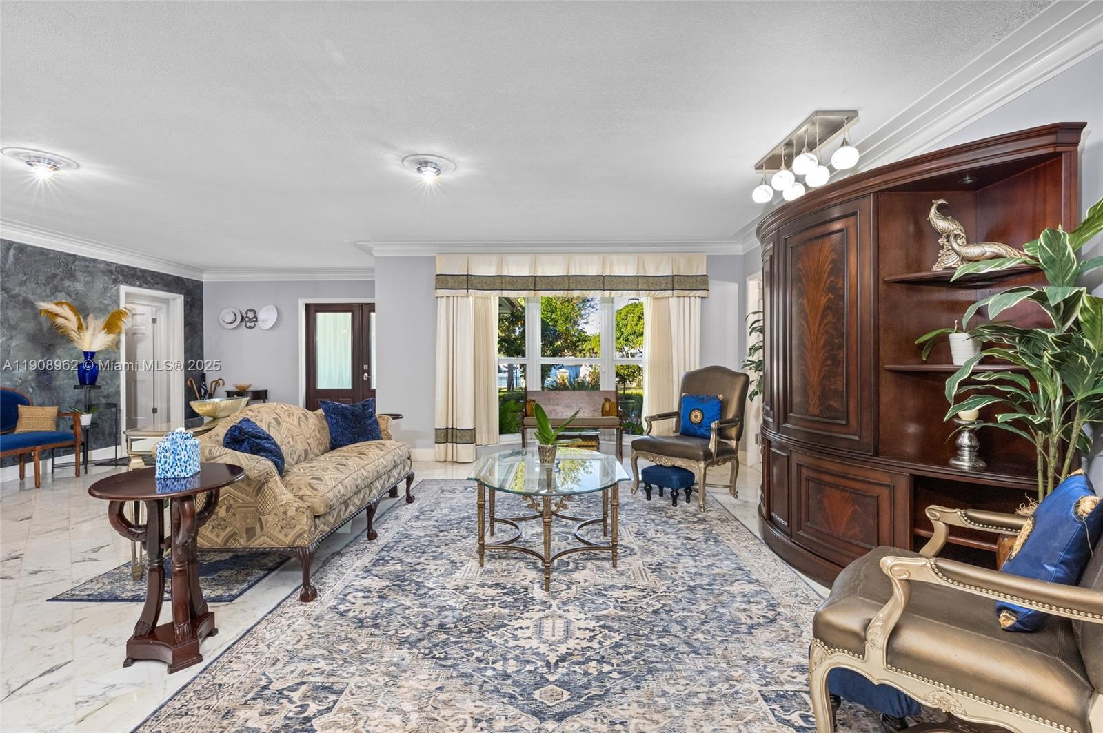 70 Bay Colony Lane Fort Lauderdale, FL 33308 - Photo 44 of 97 a living room with furniture a chandelier and a dining table