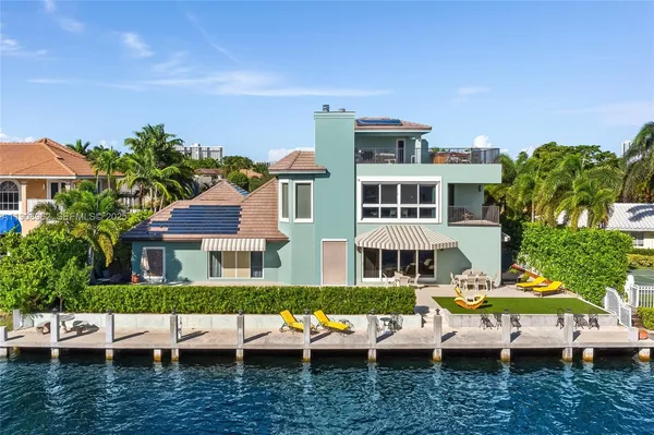 a view of a house with pool and chairs