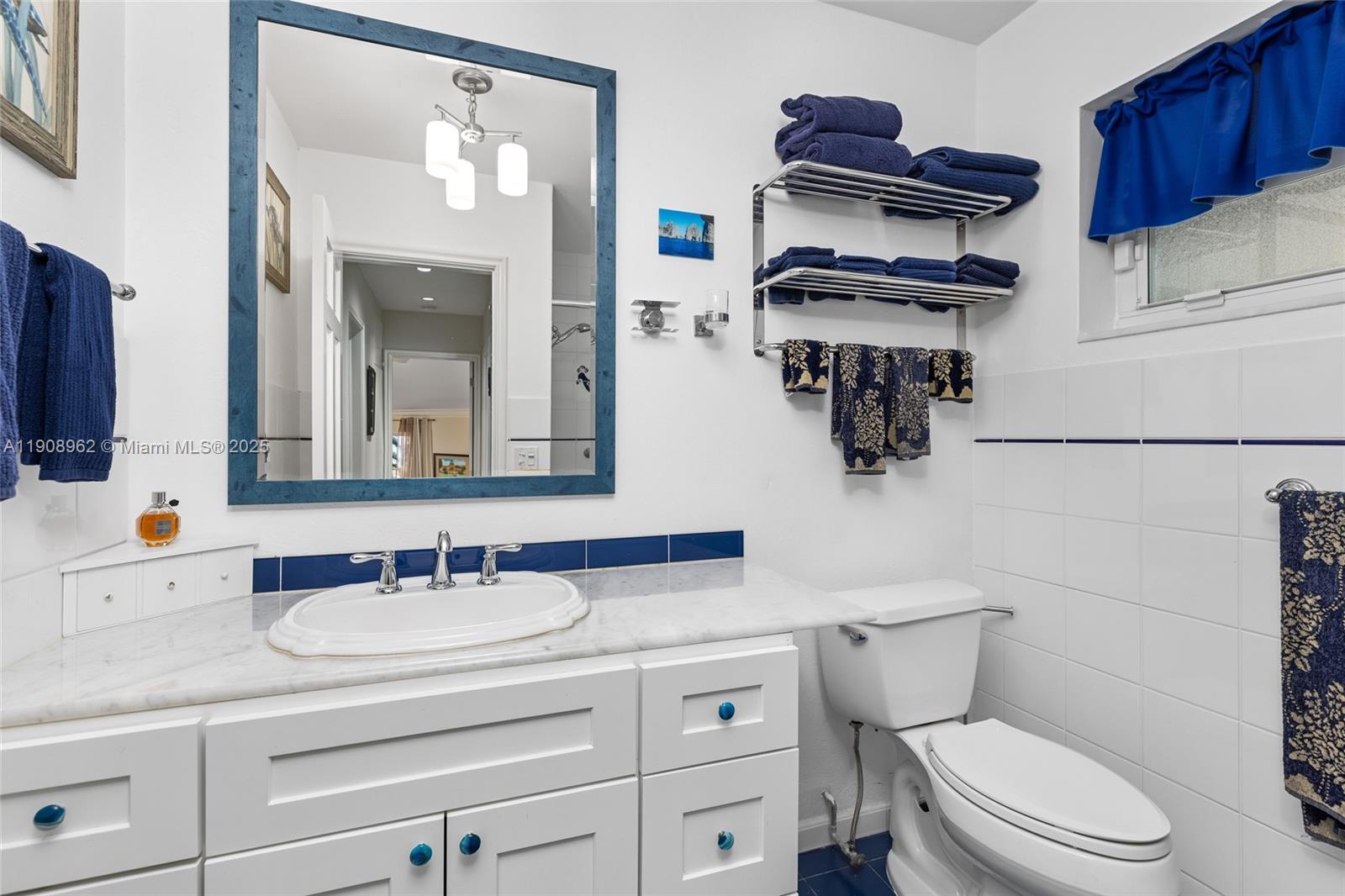 70 Bay Colony Lane Fort Lauderdale, FL 33308 - Photo 60 of 97 a bathroom with a toilet sink and mirror