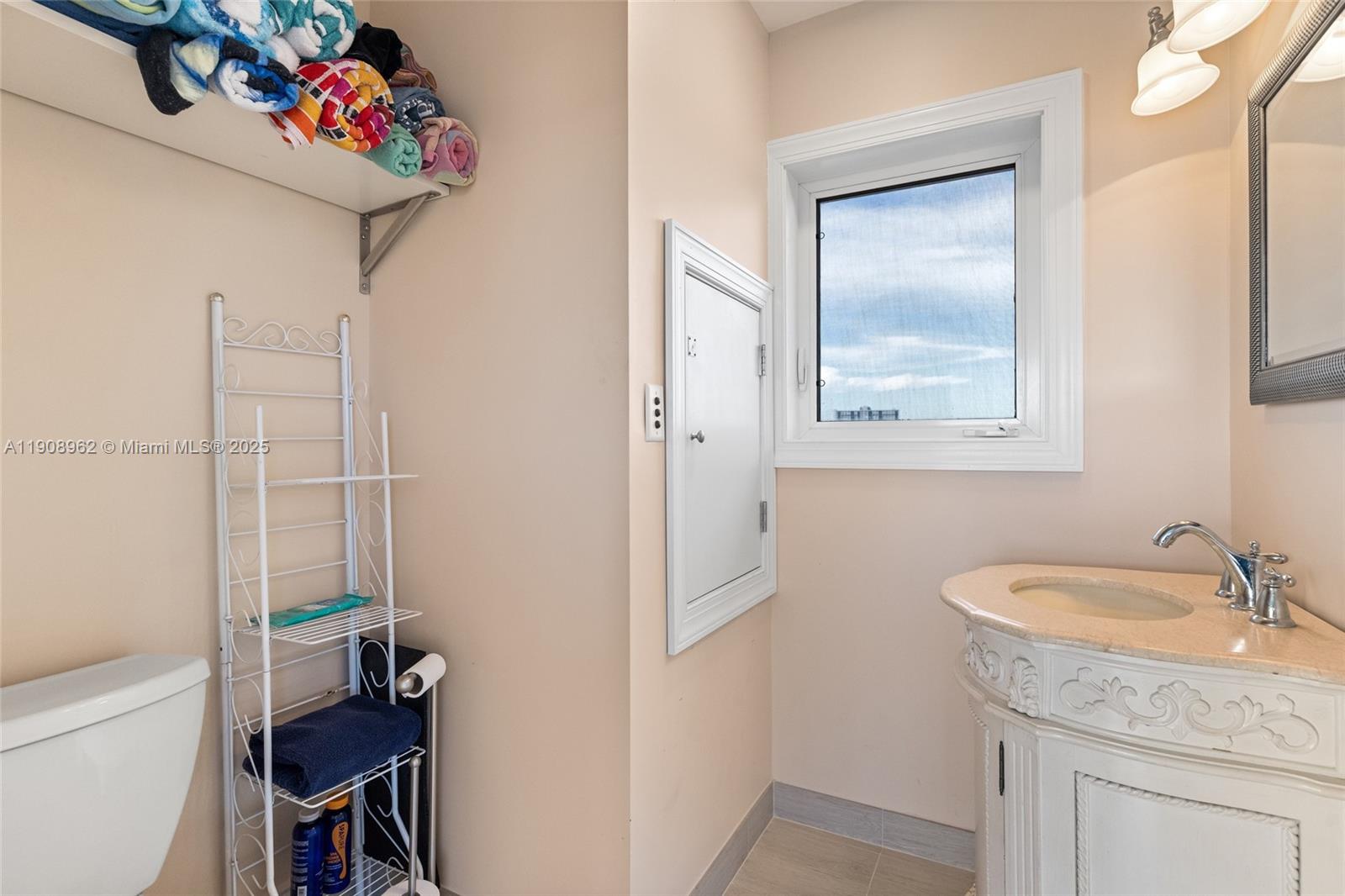 70 Bay Colony Lane Fort Lauderdale, FL 33308 - Photo 61 of 97 a bathroom with a granite countertop sink a toilet and a mirror