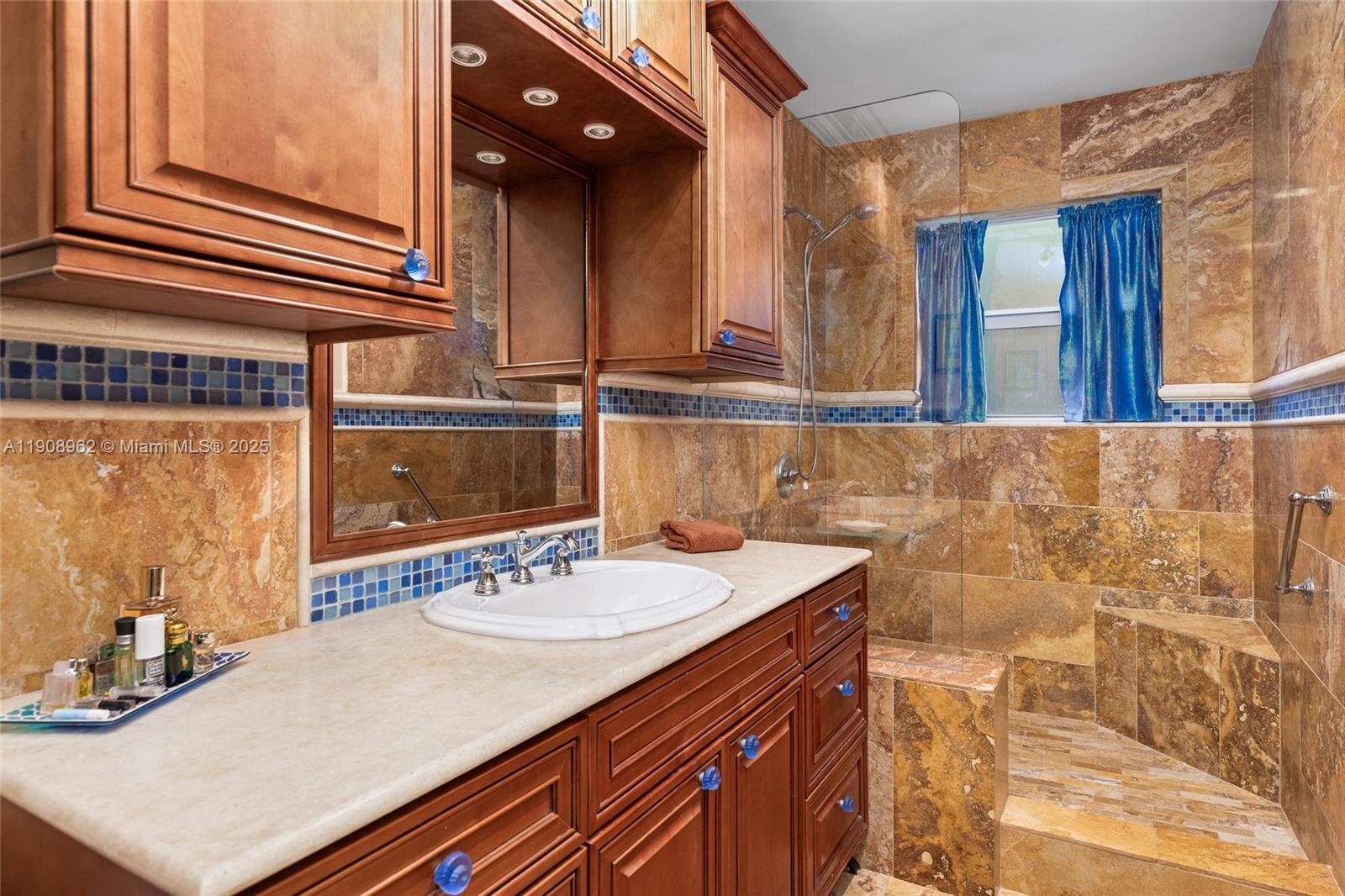 70 Bay Colony Lane Fort Lauderdale, FL 33308 - Photo 62 of 97 a bathroom with a sink and a mirror