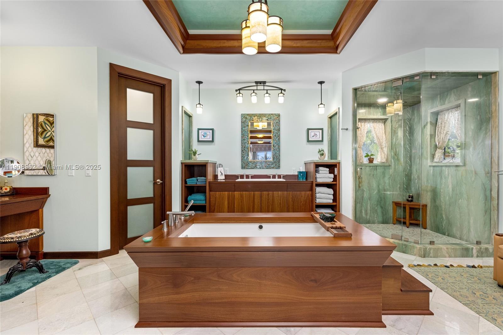 70 Bay Colony Lane Fort Lauderdale, FL 33308 - Photo 64 of 97 a living room with a mirror and a chandelier