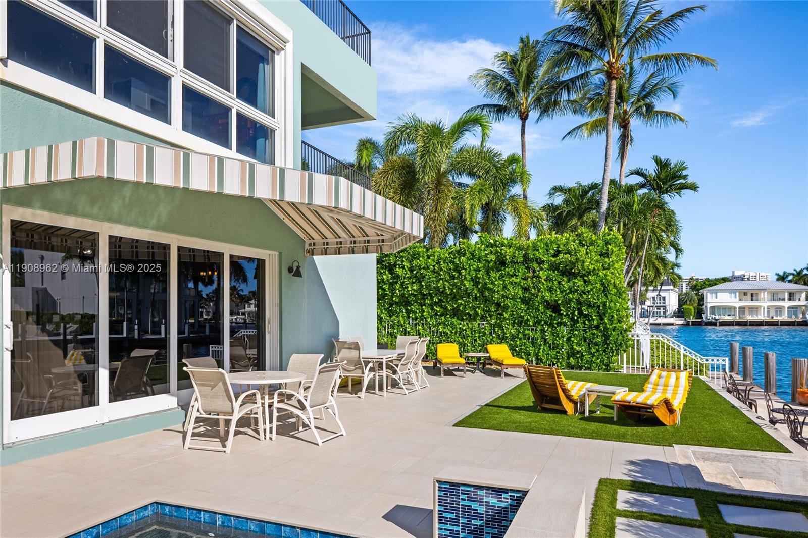 70 Bay Colony Lane Fort Lauderdale, FL 33308 - Photo 82 of 97 a view of a chair and tables in the patio and a fountain