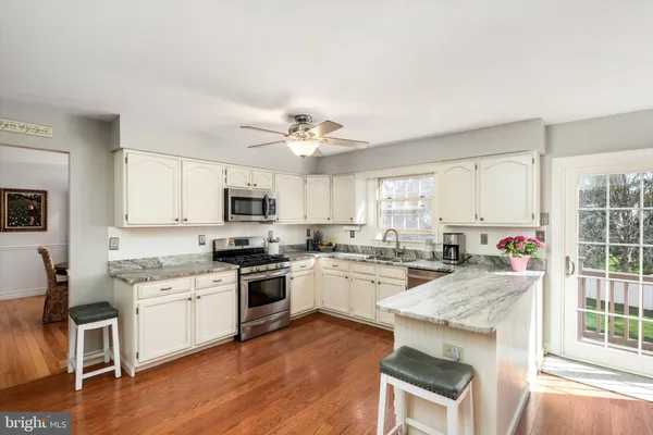 a kitchen with stainless steel appliances a refrigerator sink and microwave