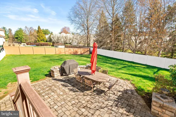 a view of a patio with table and chairs and potted plants