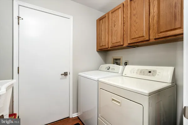a living room with furniture kitchen view and a window