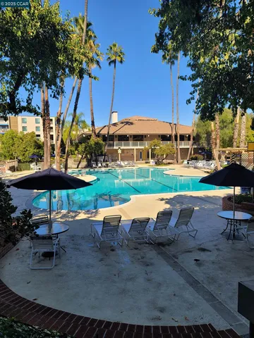 a kitchen with granite countertop white cabinets and a sink