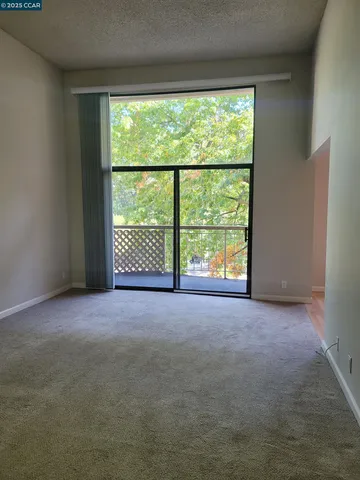 a view of a swimming pool with lawn chairs under an umbrella