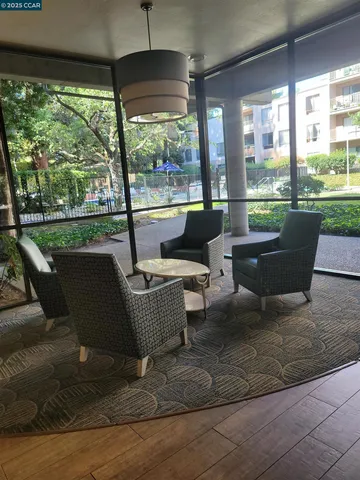 a living room with furniture a flat screen tv and a large window