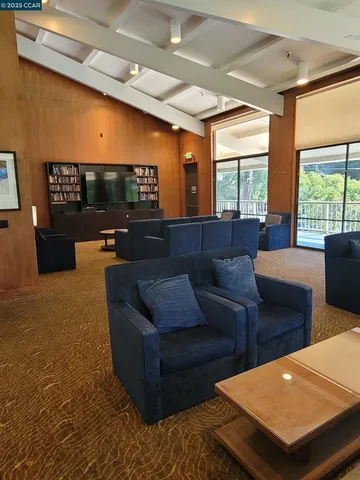 a reading room with wooden floor pool table and chairs