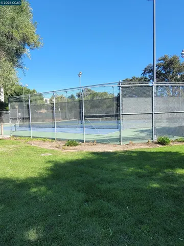 a kitchen with granite countertop white cabinets and a stove