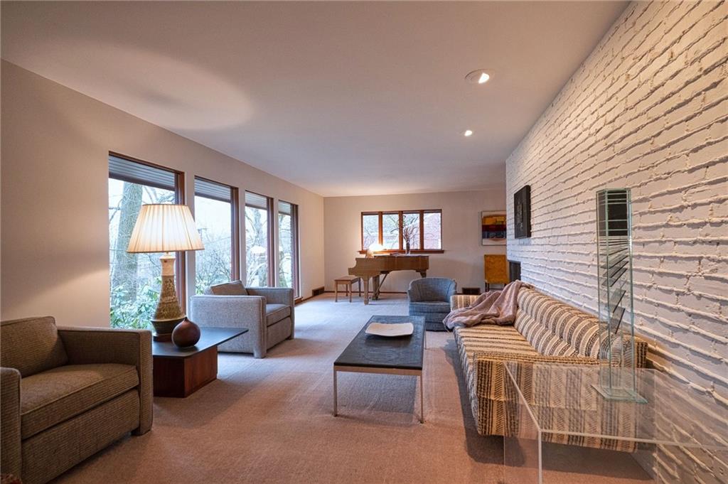 788 Elm Spring Road Pittsburgh, PA 15243 - Photo 7 of 25 Sun pours into this spacious living room through spectacular windows! Cool brick accent wall, and recessed lighting. Perfect back corner for a grand piano.