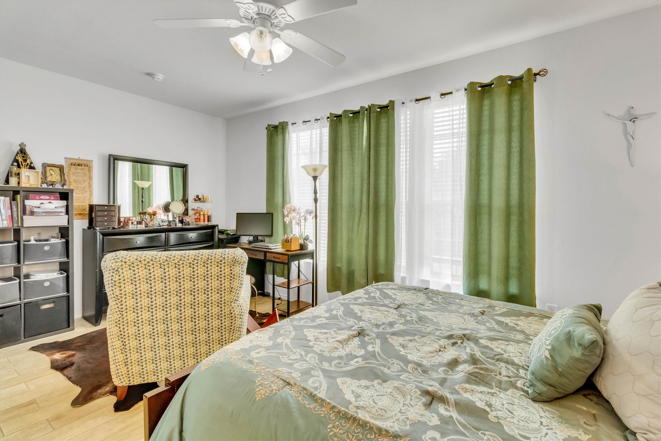 460 Waterleaf Boulevard Kyle, TX 78640 - Photo 14 of 30 Well-lit bedroom offers tile flooring, bright windows with drapes, and a functional ceiling fan.