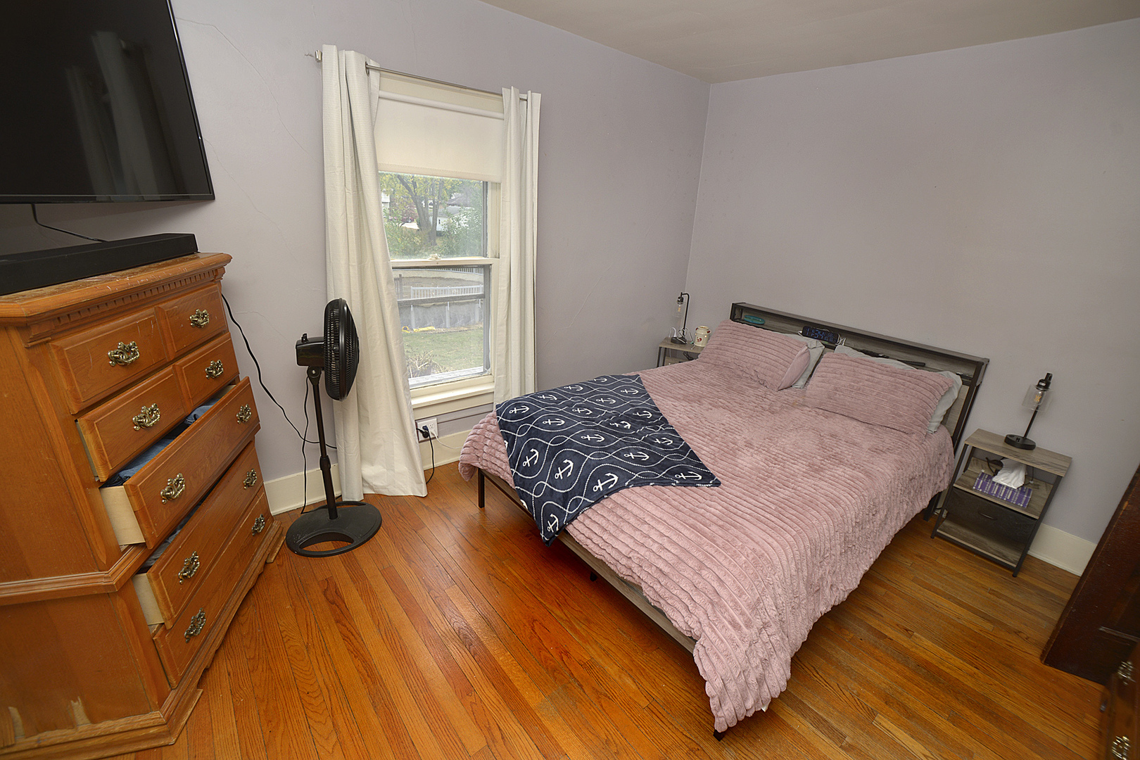 1050 State Street Ottawa, IL 61350 - Photo 16 of 25 a bedroom with a bed and wooden floor
