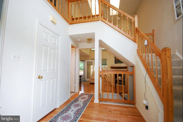 1503 Deer Point Way Reston, VA 20194 - Photo 1 of 21 a view of hallway with wooden floor and stairs