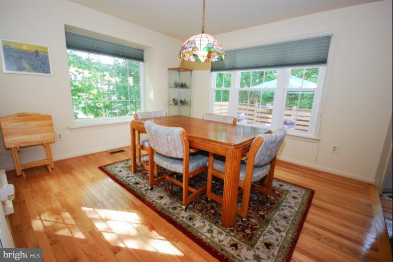 1503 Deer Point Way Reston, VA 20194 - Photo 19 of 21 a view of a dining room with furniture a rug and wooden floor