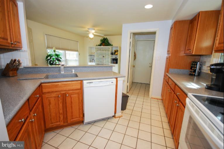 1503 Deer Point Way Reston, VA 20194 - Photo 20 of 21 a kitchen with a sink stove and cabinets