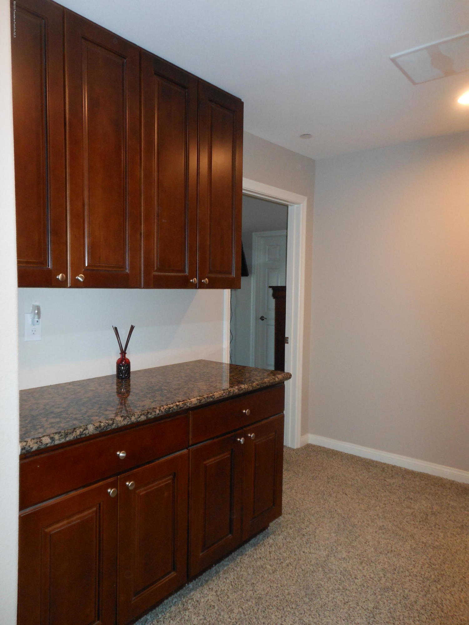 14806 Cheyenne Road Apple Valley, CA 92307 - Photo 11 of 15 a kitchen with granite countertop wooden cabinets and granite counter tops