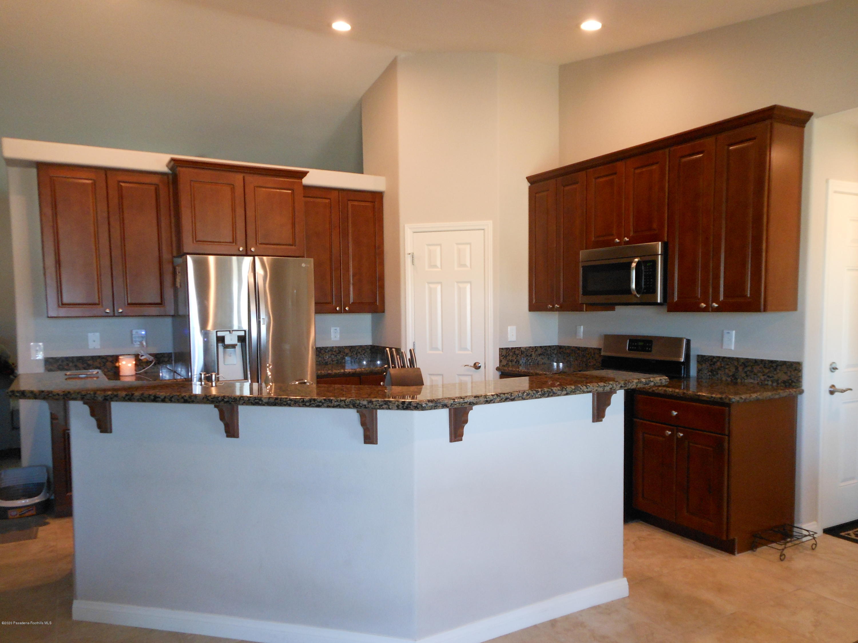 14806 Cheyenne Road Apple Valley, CA 92307 - Photo 3 of 15 a kitchen with appliances a sink and cabinets