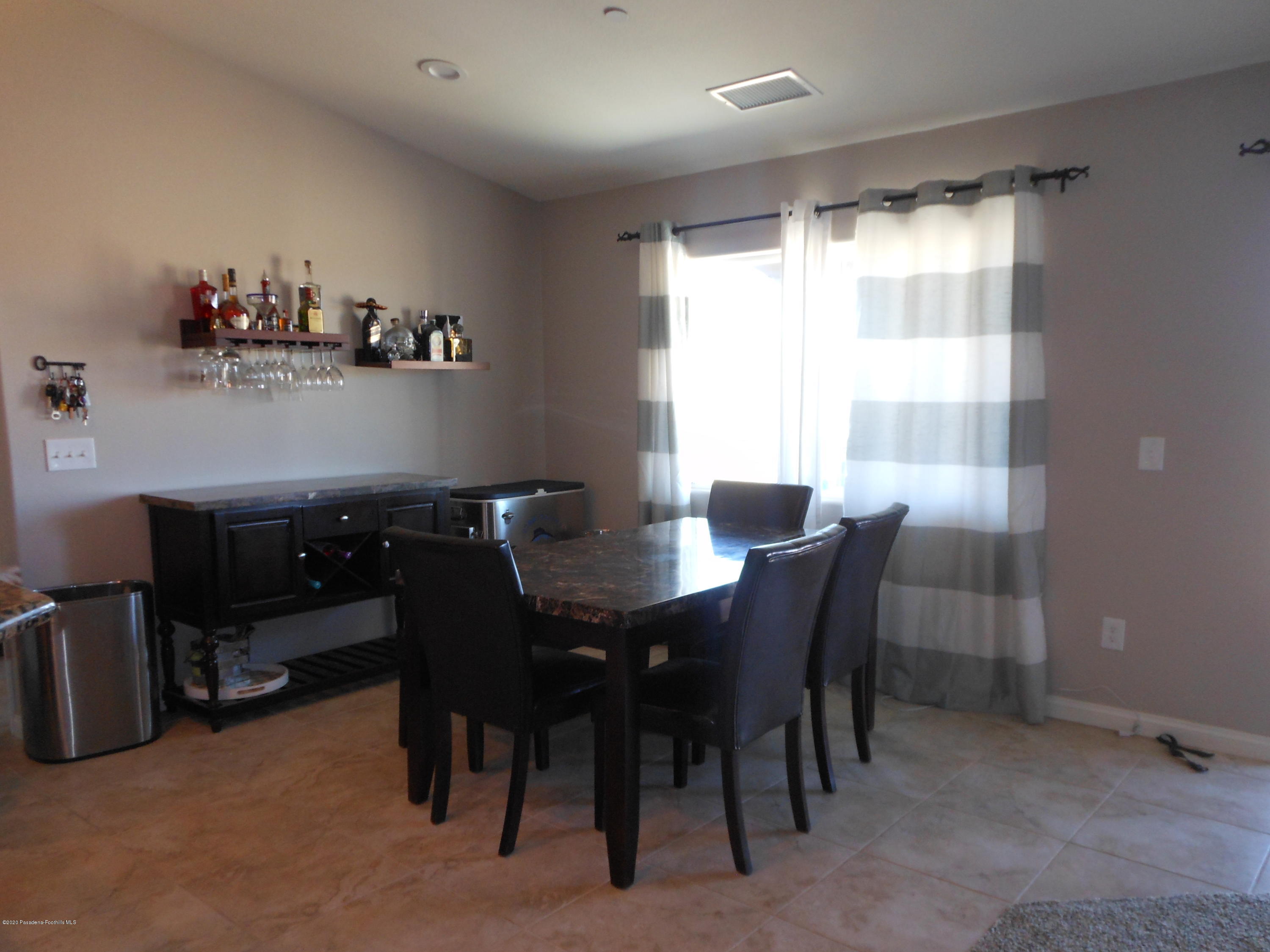 14806 Cheyenne Road Apple Valley, CA 92307 - Photo 5 of 15 a view of a dining room with furniture and a window