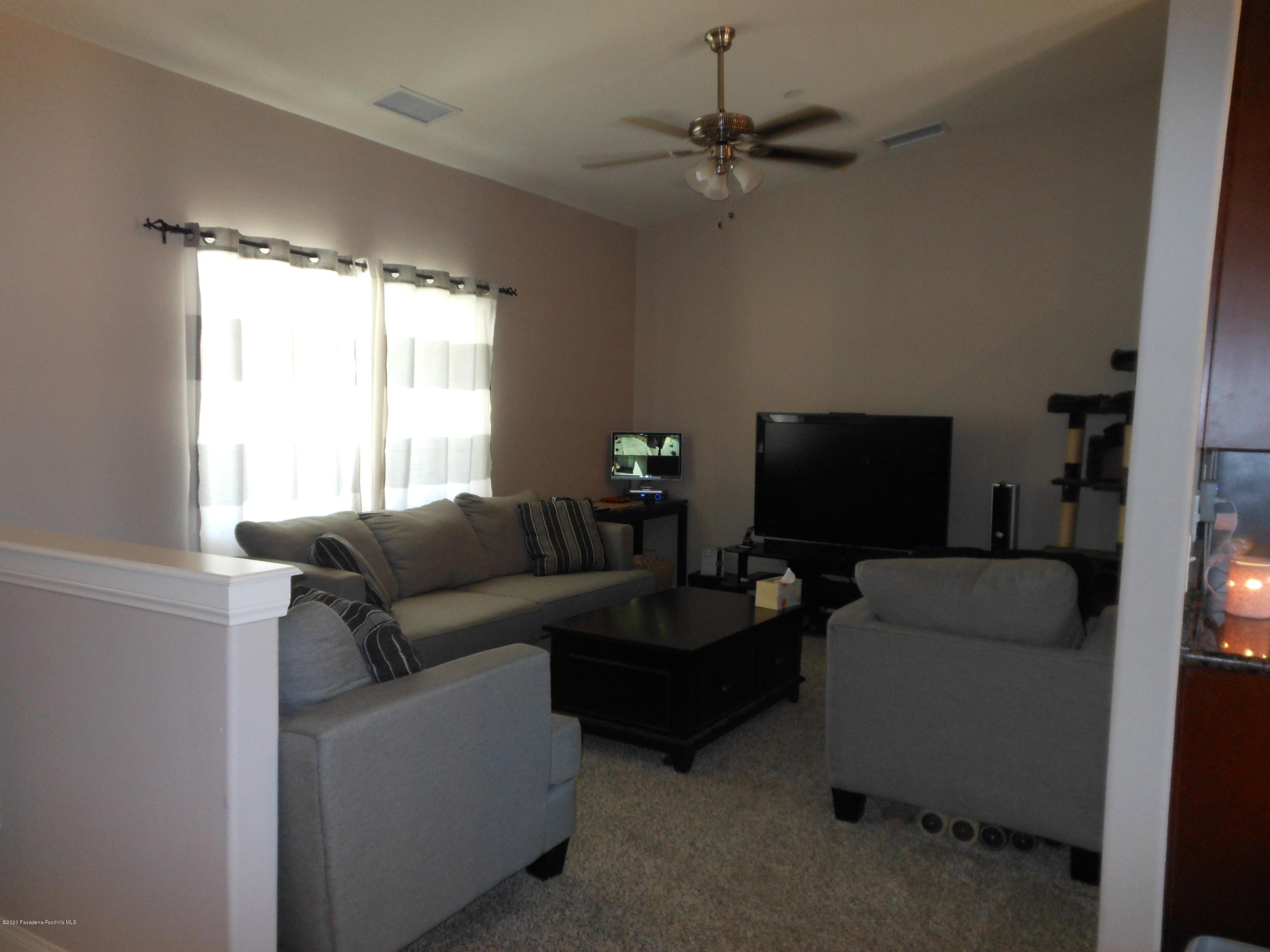 14806 Cheyenne Road Apple Valley, CA 92307 - Photo 6 of 15 a living room with furniture and a flat screen tv