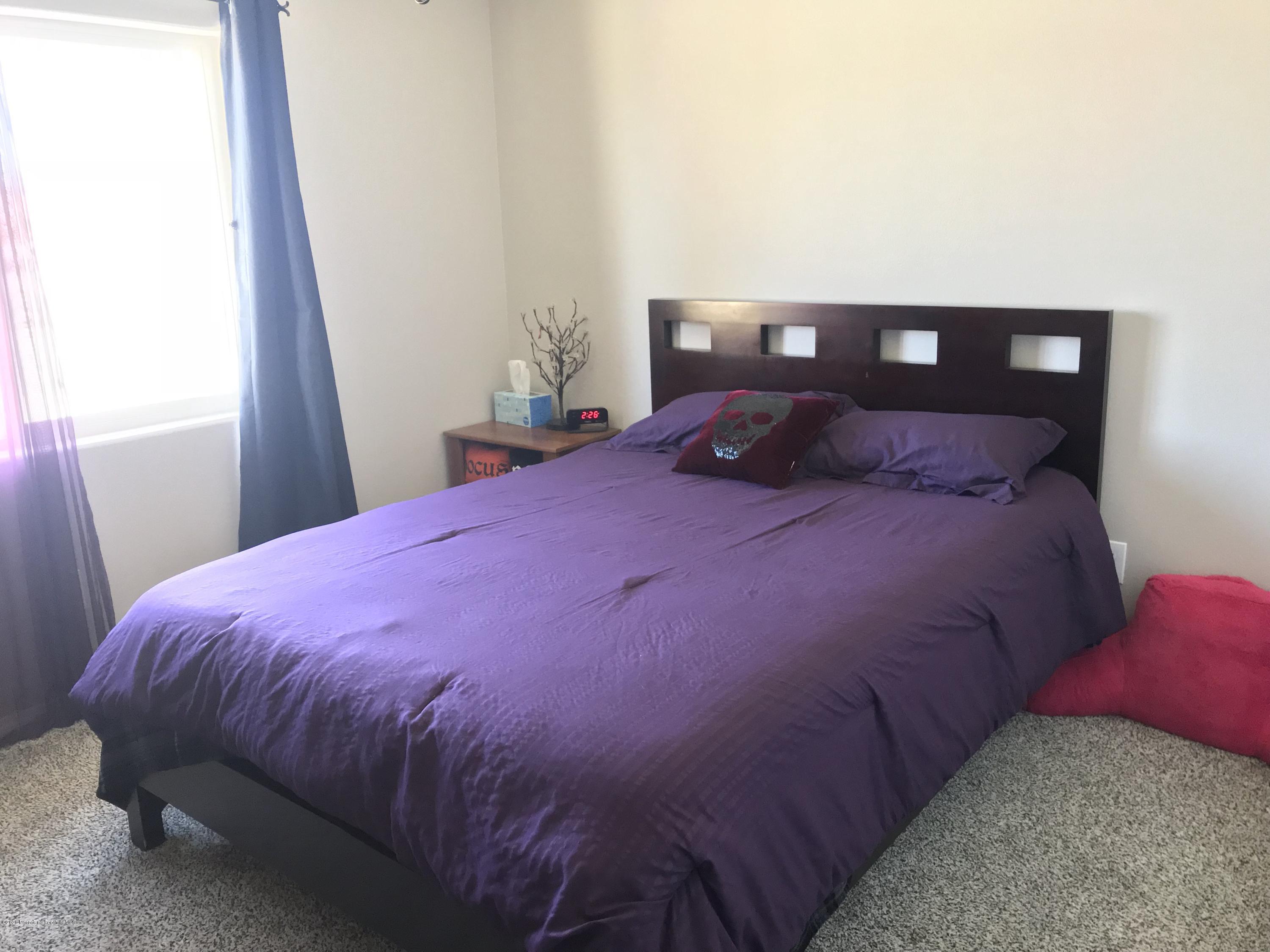 14806 Cheyenne Road Apple Valley, CA 92307 - Photo 7 of 15 a bedroom with a bed and a window